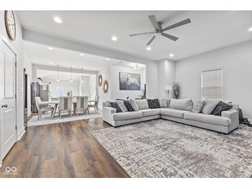 Spacious living room featuring hardwood floors and modern sectional sofa at 234 N State Ave, Indianapolis, IN 46201