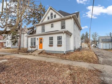 Charming two-story home featuring a bright orange door, classic architecture, and inviting curb appeal at 422 E Main St, Lebanon, IN 46052