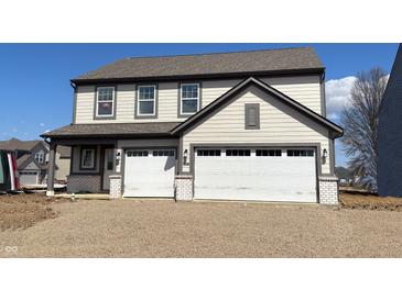 Two-story home featuring a two-car garage, gray siding, and an inviting front porch at 4396 Pine Bluff Dr, Bargersville, IN 46106