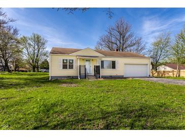 Charming one-story home with an attached garage and a well-manicured front yard at 5757 E 21St St, Indianapolis, IN 46218