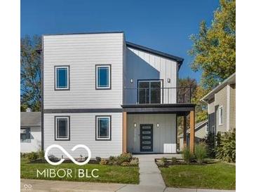 Modern two-story home with white siding, black trim, and small balcony at 3238 Guilford Ave, Indianapolis, IN 46205