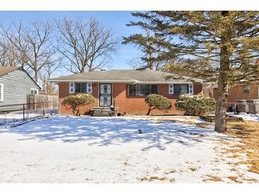 Charming brick home with a well-maintained front yard and winter landscaping at 4139 N Grand Ave, Indianapolis, IN 46226