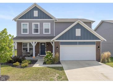 Charming two-story home featuring a brick facade, gray siding, a well-manicured lawn, and an attached two-car garage at 4345 Indigo Walk Ln, Indianapolis, IN 46239