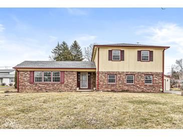 Charming two-story home featuring brick and siding with red shutters and a well-maintained front yard at 5465 Leone Dr, Indianapolis, IN 46226