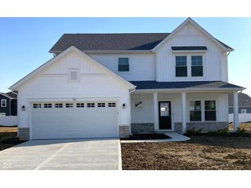 Charming two-story home showcasing a white exterior, attached garage, and well-manicured lawn at 7161 Jackson Dr, Cumberland, IN 46229