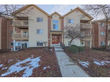 Attractive condo building with brick accents and inviting red door at 1057 Timber Creek Dr # 1, Carmel, IN 46032