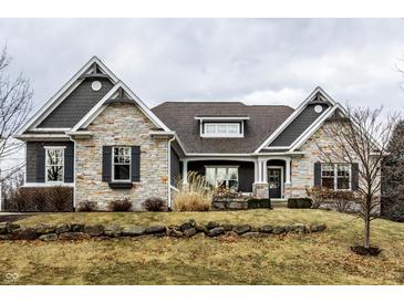 Charming two-story home featuring stone accents, well-maintained landscaping, and an inviting front entrance at 16882 Oak Manor Dr, Westfield, IN 46074