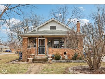 Charming brick home with a cozy front porch, perfect for relaxing outdoors at 3103 S Lockburn St, Indianapolis, IN 46221