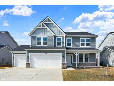 Charming two-story home with a two-car garage, manicured lawn, and inviting front porch at 526 Carroll St, New Whiteland, IN 46184