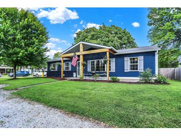 Charming navy blue home with new covered porch, healthy green lawn, and a welcoming front yard at 790 N 14Th St, Noblesville, IN 46060