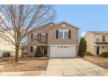 Charming two-story home featuring a two-car garage, well-maintained lawn, and classic architectural details at 8394 S Shady Trail Dr, Pendleton, IN 46064