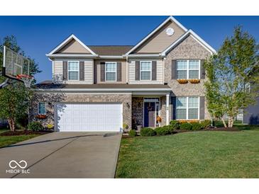 Charming two-story home with a well-maintained lawn, attached two-car garage, and beautiful brick and siding facade at 8416 Whitaker Valley Blvd, Indianapolis, IN 46237
