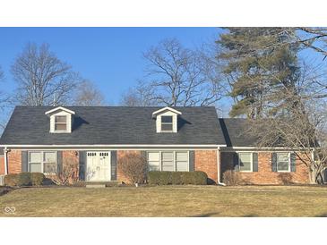Charming single-story brick home with dormer windows, shutters, well-manicured lawn, and a classic double door entry at 8888 Cholla Rd, Indianapolis, IN 46240