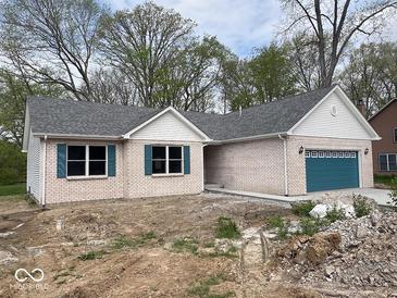 Charming brick home with gray roof, teal shutters, and a teal garage door at 103 N Brenrich Rd, Pendleton, IN 46064
