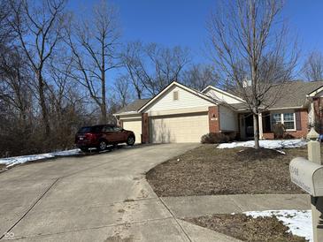 Charming single-Gathering home with a two-car garage and an extended driveway, perfect for multi-car families at 1148 Nanwich Ct, Indianapolis, IN 46217