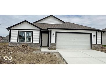 Charming single-story home featuring white siding, a two-car garage, and a stone foundation accent at 1414 Bluebonnet Pl, Shelbyville, IN 46176