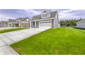 Charming two-story home featuring a well-manicured lawn and an attached two-car garage at 16822 Imperial Ct, Fishers, IN 46040