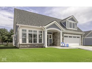 Charming home featuring stone accents, a manicured lawn, and a two-car garage at 16822 Imperial Ct, Fishers, IN 46040