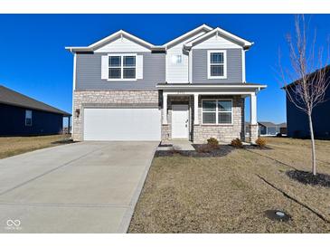 Charming two-story home featuring a stone facade, gray siding, well-manicured lawn, and a convenient two-car garage at 2976 W Tapestry Dr, Monrovia, IN 46157