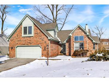 Charming brick home with an attached garage and snow-covered yard at 60 Huddleston N Dr, Indianapolis, IN 46217
