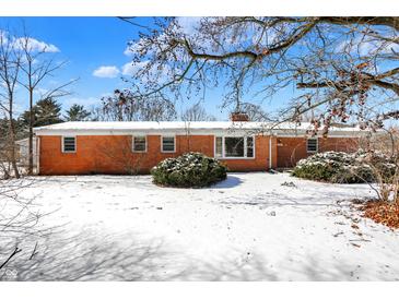 Charming brick home with a cozy, well-maintained exterior and snowy front yard at 6838 Hague Rd, Indianapolis, IN 46256