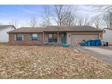 Charming single-story home with a brick facade and an attached garage at 817 Delray Dr, Indianapolis, IN 46241