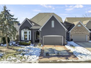 Charming brick home featuring a two-car garage, a well-manicured lawn, and a classic architectural design at 11338 Bayhill Way, Indianapolis, IN 46236
