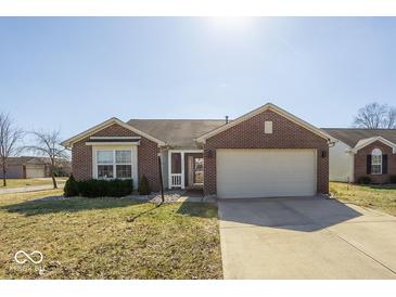 Charming brick home featuring an attached two-car garage and manicured front lawn at 12329 Wolf Run Rd, Noblesville, IN 46060