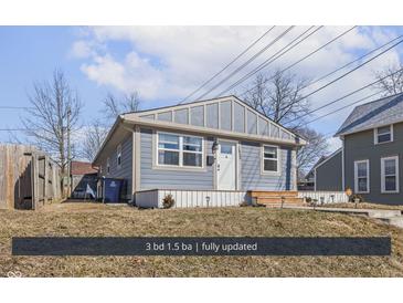 Charming single-story home with a well-maintained lawn and inviting front porch at 1420 E Market St, Indianapolis, IN 46201