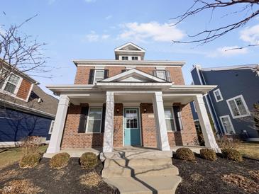 Charming two-story brick home featuring a covered front porch with white columns at 1670 Rossmay Dr, Westfield, IN 46074
