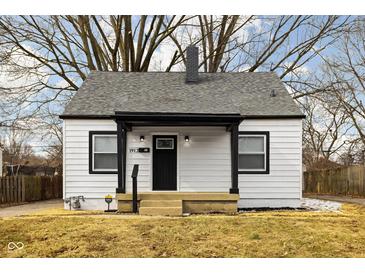 Charming home featuring a gray roof, black trim, and a cozy front porch perfect for relaxing at 1912 Glenridge Dr, Indianapolis, IN 46218