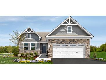 Charming single-Gathering home featuring a two-car garage, stone accents, and beautiful landscaping at 2194 Walnut Fork Dr, Whitestown, IN 46075