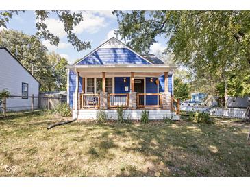 Charming blue home featuring a quaint front porch with stone accents and a well-maintained lawn at 2224 E Pleasant Run Parkway North Dr, Indianapolis, IN 46203