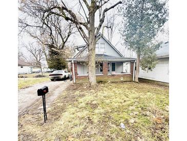 Charming two-story home with a quaint front porch and an expansive front yard at 3209 Bethel Ave, Indianapolis, IN 46203