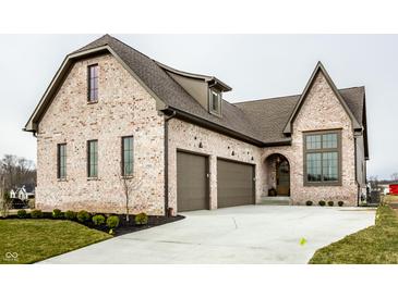 Elegant brick home with a two-car garage and manicured landscaping enhances curb appeal at 3588 Marketplace Ct, Zionsville, IN 46077
