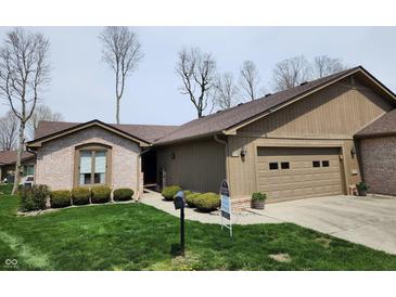 Charming single-story home with a two-car garage and well-manicured lawn and appealing landscaping at 3636 Woodglen Way, Anderson, IN 46011