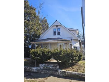 Charming home featuring a screened porch and mature landscaping at 439 N Colorado Ave, Indianapolis, IN 46201