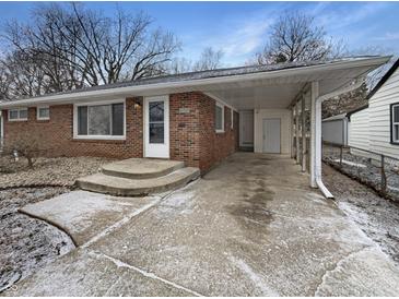 Charming single-story brick home with carport and well-maintained front yard at 4721 N Longworth Ave, Indianapolis, IN 46226