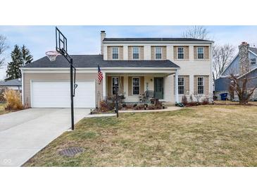 Charming two-story home features a brick facade, attached garage, and front porch with swing at 803 Hickory Way, Noblesville, IN 46062