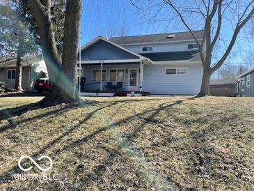 Charming two-story home with a covered porch and mature trees in a quiet neighborhood at 1437 E Pleasant Run Pkwy S Dr, Indianapolis, IN 46203