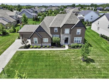 Beautiful brick two-story home featuring a well-manicured lawn and attached two car garage at 15694 Provincial Ln, Fishers, IN 46040