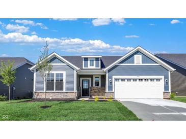 Charming single-story home boasts blue siding, stone accents, a two-car garage, and a well-manicured lawn at 19714 Highclere Ln, Sheridan, IN 46069