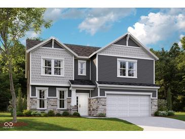 Charming two-story home with stone accents and a two-car garage, perfect for Gathering living at 7348 Deerberg Dr, Indianapolis, IN 46259