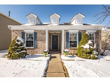 Charming brick home with a well-maintained lawn and inviting entrance, perfect for a cozy Gathering living at 13414 Allegiance Dr, Fishers, IN 46037