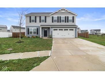 Attractive two-story home with a well-maintained lawn and a two-car garage at 13860 N Tiosa Ln, Camby, IN 46113