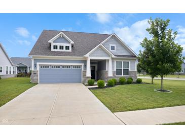 Charming single Gathering home with a well-maintained lawn and a two-car garage at 16401 Brigham Ln, Westfield, IN 46074