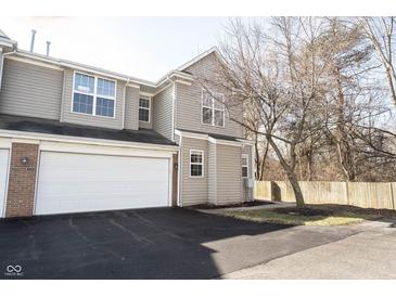 Inviting townhouse featuring a two-car garage and neutral siding at 2332 Brightwell Pl, Indianapolis, IN 46260