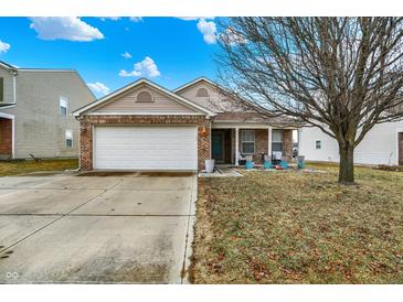 Charming single-story brick home with an attached two-car garage and inviting front porch at 4318 Ballybay Ln, Indianapolis, IN 46239
