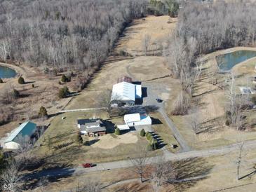 Expansive property featuring home, large barns, ponds, and natural surroundings in a rural setting at 5420 W Goeller W Rd, Columbus, IN 47201