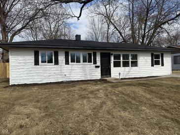 Charming single-story home with a freshly painted white exterior and black accents on a sunny, winter day at 5546 Marilyn Rd, Indianapolis, IN 46226
